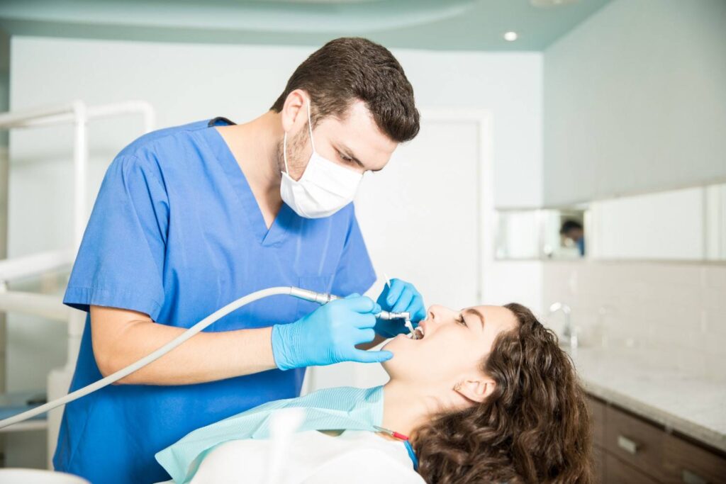 young-woman-receiving-dental-treatment-from-male-dentist-clinic (1)